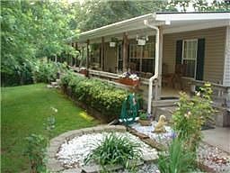 Wonderful home on 7.25 acres. Porch Wraps around 2 sides. 