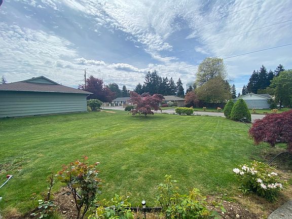 Large front yard with a beautiful view of the sunset.