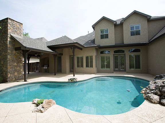 The lagoon Pool and covered Living area offer the best of fun and relaxation! Enhanced by scored coo