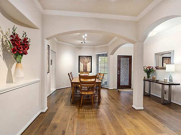 Your formal dining area is the perfect hub for a great party or large dinner with easy access to the other parts of the home. You'll love the high end wood flooring and feature arches with curved corners.