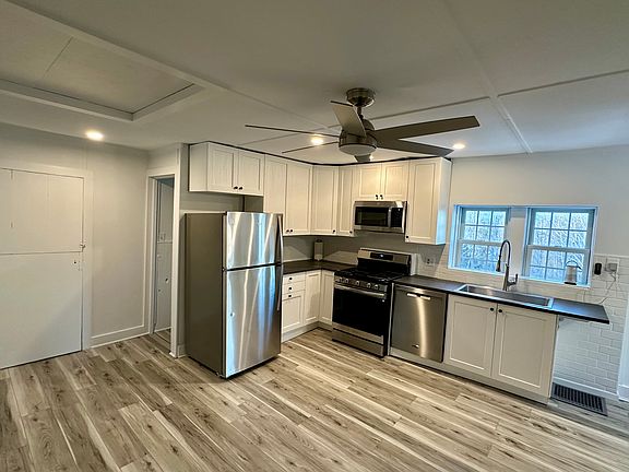 2nd floor kitchen with Anderson windows. All new cabinets, fridge, microwave, dishwasher, sink, counters, ceiling fan, and flooring. Freshly painted.