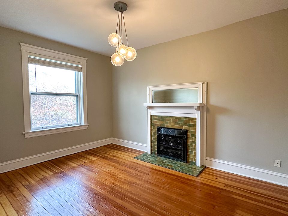 Large primary bedroom with original fireplace (decorative)