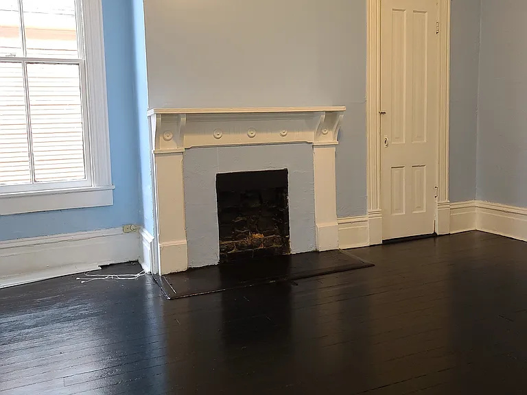 Middle room showing fireplace, window and closet.