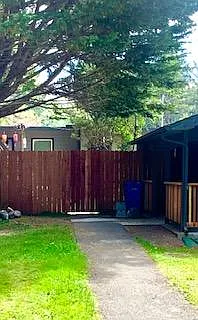 Entrance through fence gate.