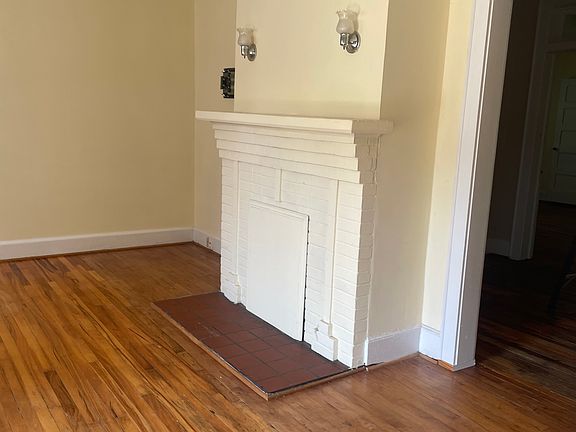 Living room with working firer place. Two light Sconces over mantel.