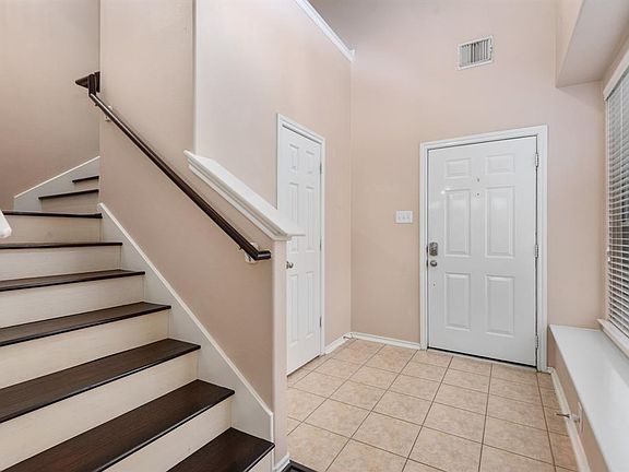 High ceilings and a light and bright entry way welcome all who enter! The half bath to the left here is perfectly appointed for guests. There is a huge window along with a convenient window seat in this space as well.