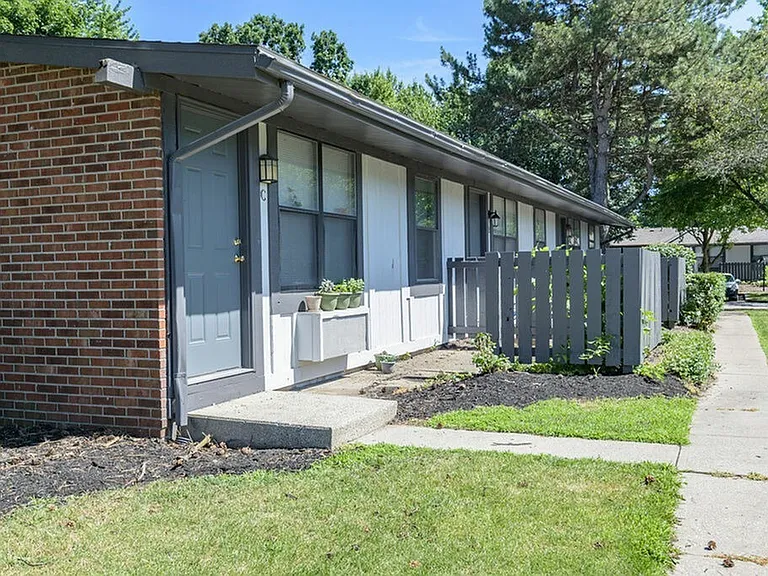 Front of apartment building with new landscaping featuring one level living