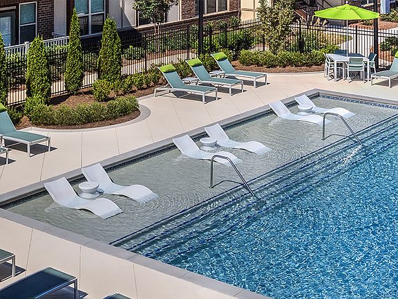 Resort-style pool with sun shelf and ample loungers