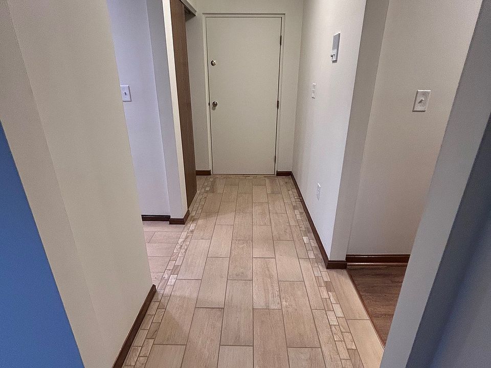 Entry Hallway view from Living Room to Entry door with ceramic tile