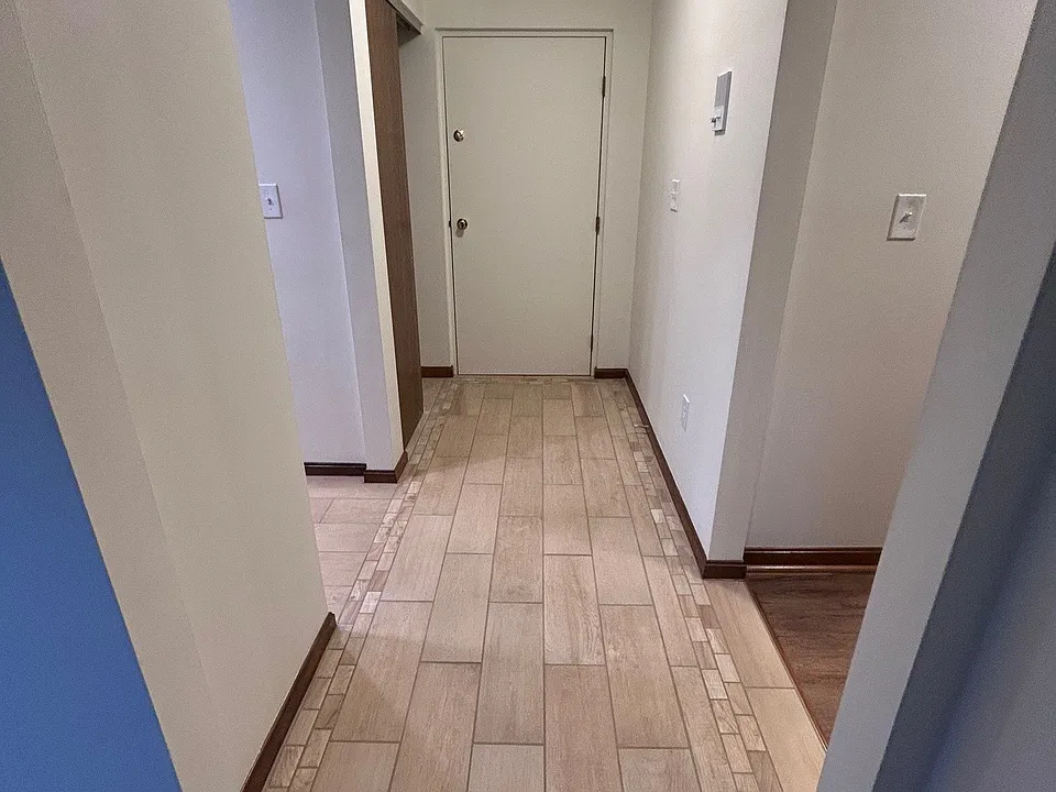 Entry Hallway view from Living Room to Entry door with ceramic tile
