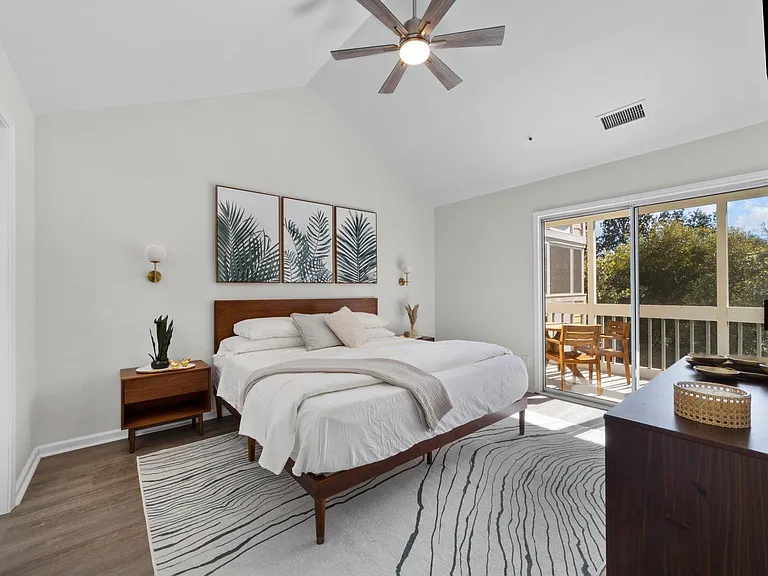 Primary bedroom with king bed. Access to screened in porch.