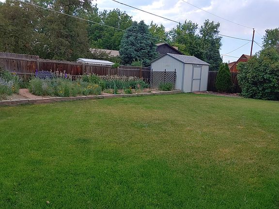 Back yard, flower garden and storage shed