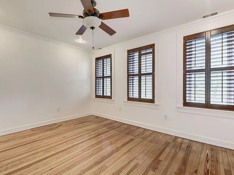 Master bedroom with large closet and three large south-facing windows