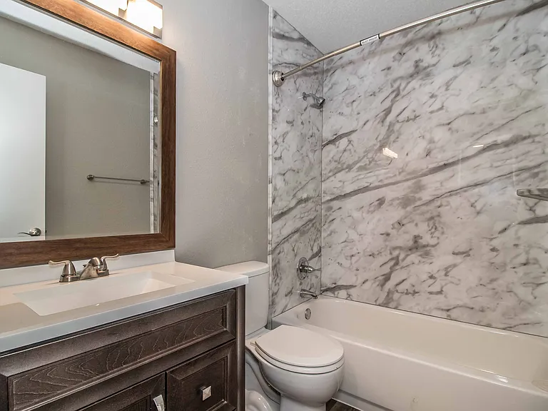 Refresh in your clean, well-lit bathroom featuring updated fixtures.