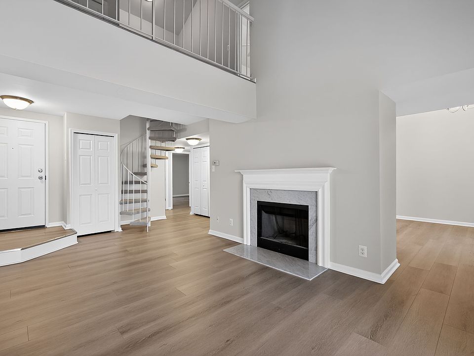 Living Room with Fireplace & Spiral Staircase to Loft & 3rd Bedroom
