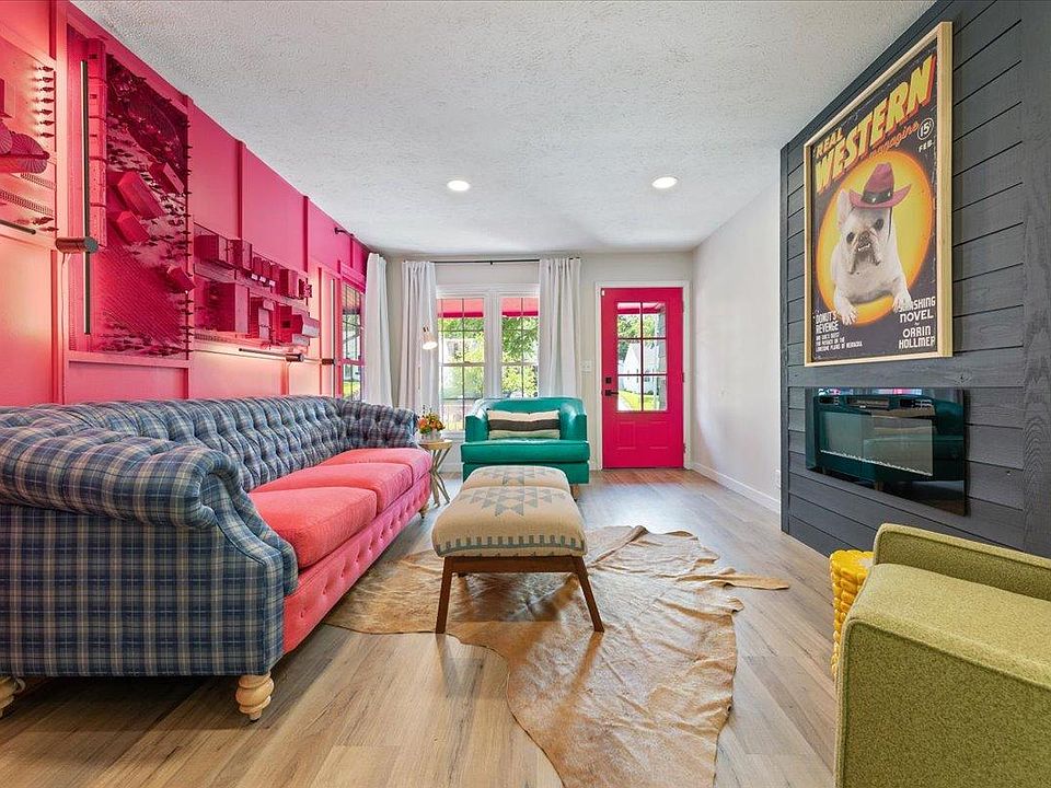 Living room with electric fireplace and art installation inspired by Union Pacific.