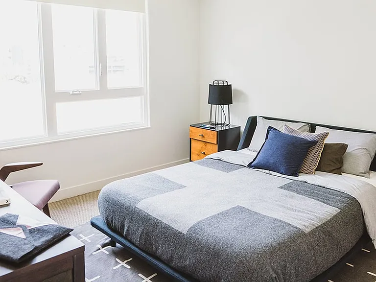 Large bedrooms featuring carpeted flooring and ample closet space