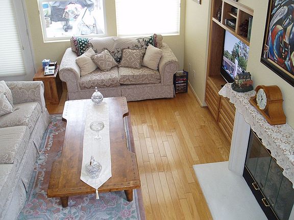 living room with wood floors and built in entertainment center