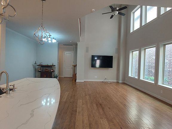 Huge living area which includes a large mounted television.