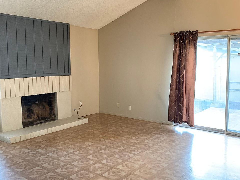 Living room with fireplace and sliding door.