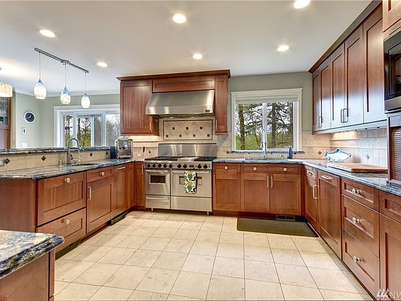 This kitchen is amazing and is sure to delight any chef who needs the space and storage provided here. High end stove and three dishwashers!
