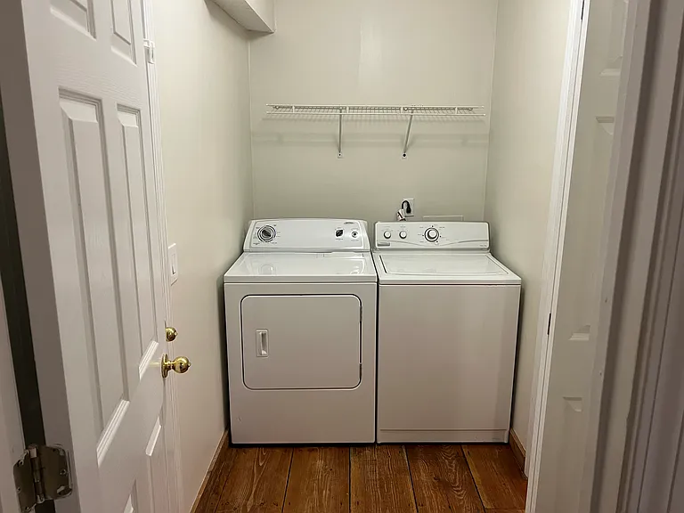 Shared main level washer/dryer and laundry space.