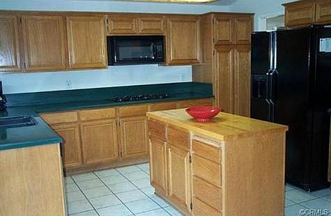 SPACIOUS KITCHEN WITH UPGRADED CORIAN COUNTERS A BUTCHER BLOCK C