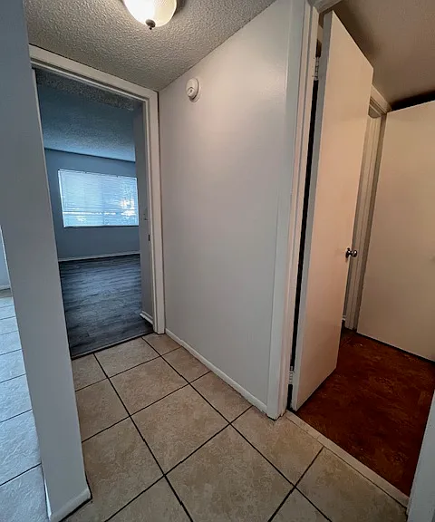 Hallway view of bed and bath