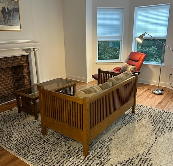 Living room with bay windows and hardwood floors
