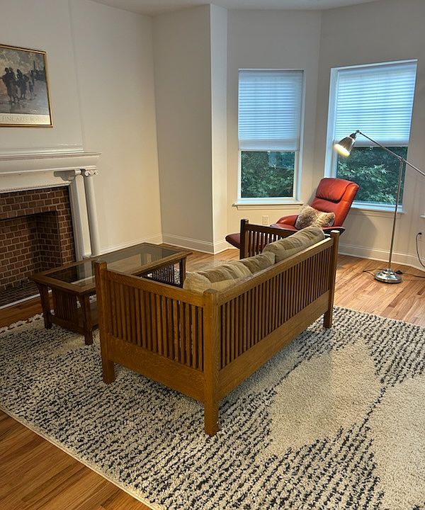 Living room with bay windows and hardwood floors