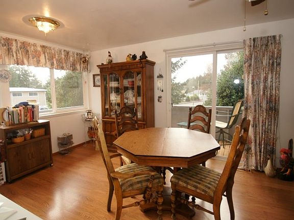 The eating area off the kitchen with slider to side deck. There are numerous vinyl windows throughout making this home nice and bright.