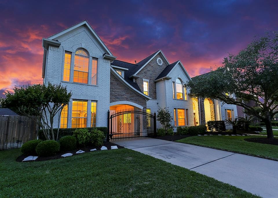 Gated Driveway leads to Auto Court and Garages