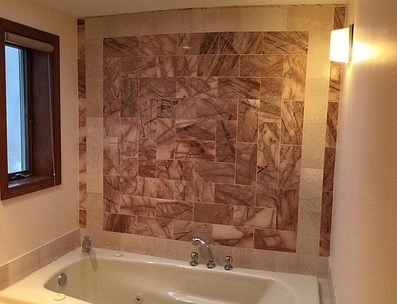 Marble Tiled Master Bath : Both Jacuzzi bathtub and shower. Skylight and window for natural light.