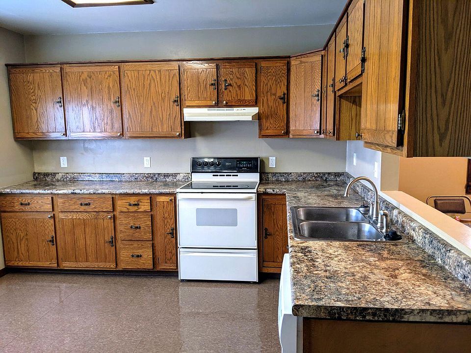 Large eat-in kitchen with stove, dishwasher and refrigerator.