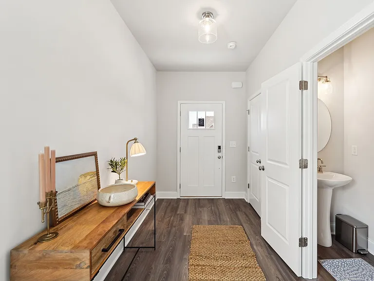 Welcoming entrance of the Rosewood floor plan with a view of the half bath.