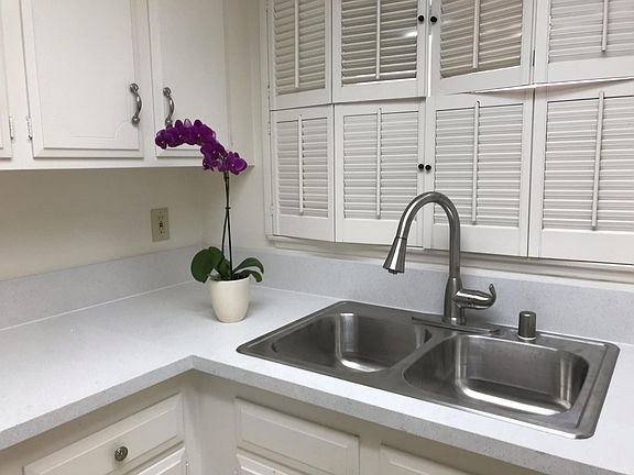 Kitchen with a brand new granite countertop, new sink and faucets, and plenty of storage