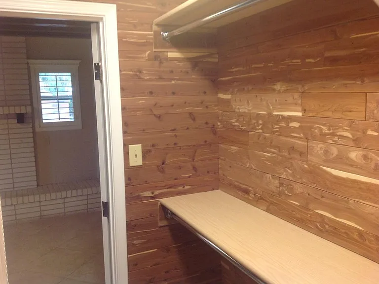 Hers Cedar lined master bedroom closet with jewelry clost