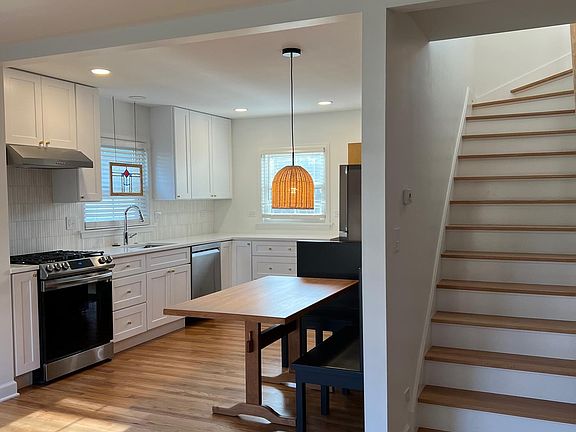 Bright eat in kitchen with tons of storage & stainless steel appliances.