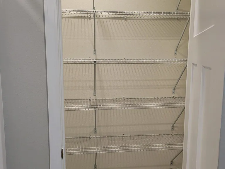 Large linen and storage closet in guest bathroom