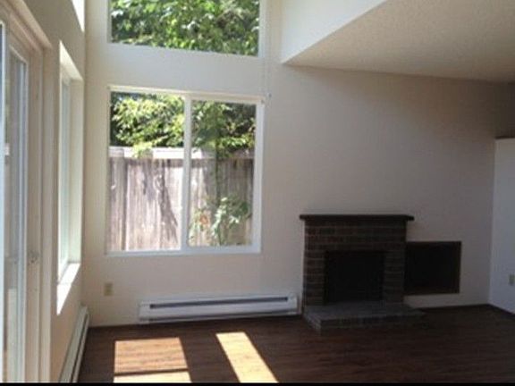 Living room with fireplace leads out to the fully fenced patio ( built in firewood holder to the right of the fireplace)