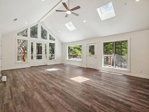 Open floor plan of living room out to deck.