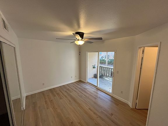 Primary bedroom with en suite, spacious closet, and sliding glass door to first floor patio