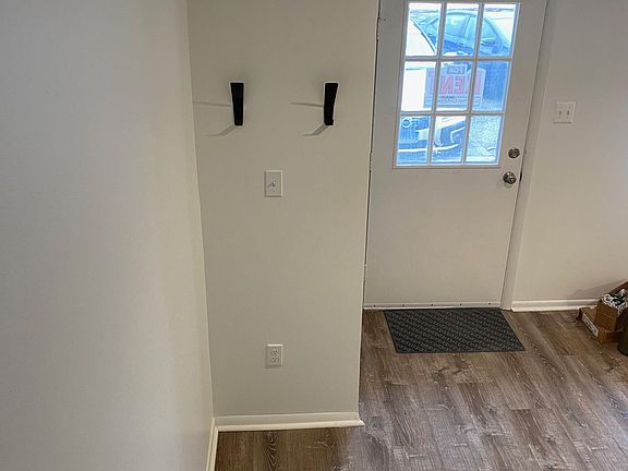 Entry way with new hall closet. All new floors.