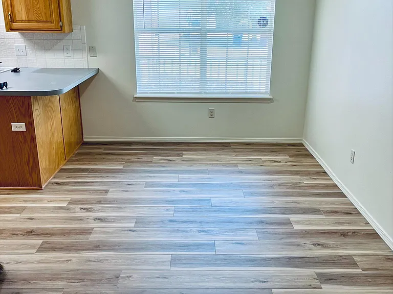 Dining area next to kitchen with window to front yard
