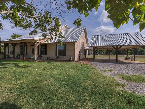 A view of the oversized carport. The private road and driveways are slag.