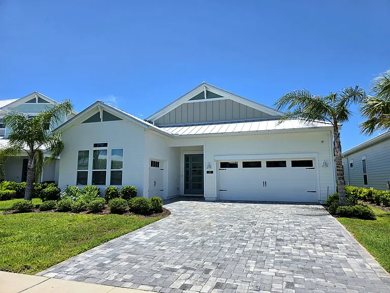 Widened paver driveway and dual-garage setup (2-car + golf cart)