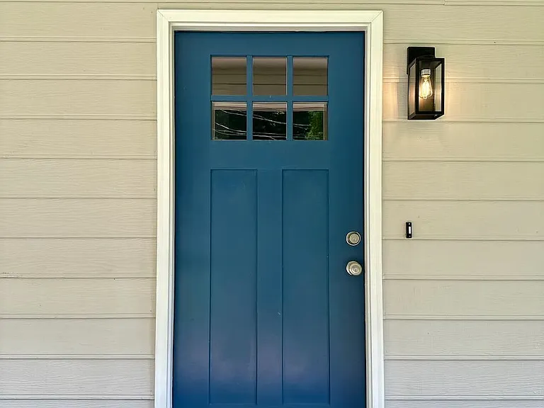 Inviting entryway_ - freshly painted blue door and modern lantern light create a bright welcome - step onto the porch and feel right at home from the very first look