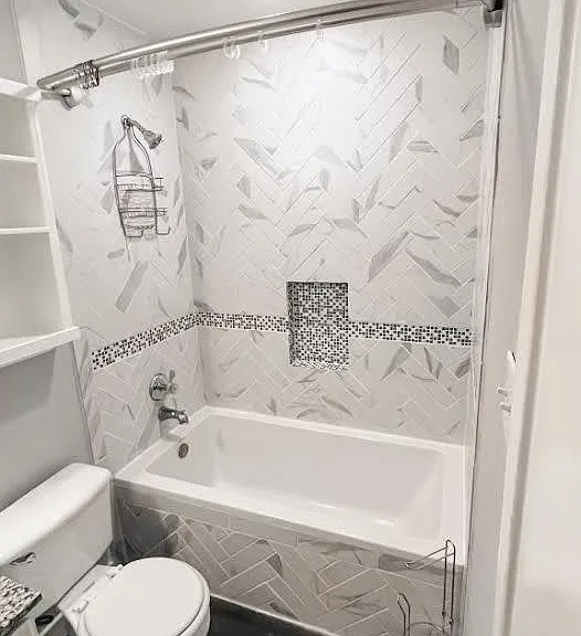 1st bathroom. Deep soaker tub, double curtain rack, recessed built-in over-toilet storage, and medicine cabinet