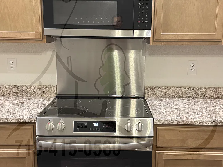 Kitchen Stove / Microwave with Stainless Steel Backsplash