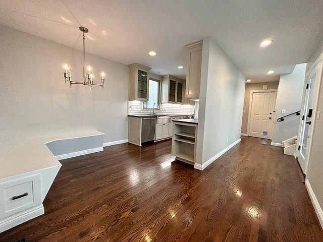 kitchen and hallway leading to garage and upstairs